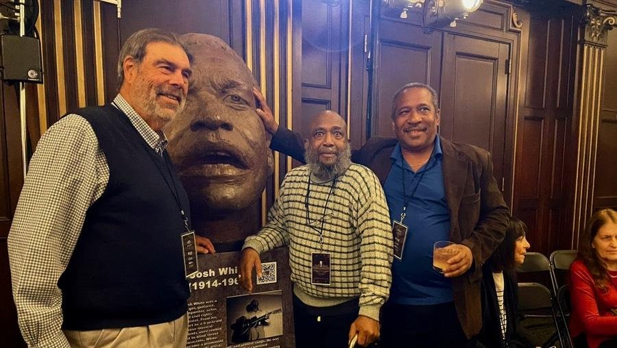 Joe Spaulding, former Director of the Boch Center and Founder of the Folk Americana Roots Hall of Fame (FARHOF); LeQuire’s sculpture of Josh White; Josh White, Jr.; Josh White, III, taken at FARHOF March 2024.