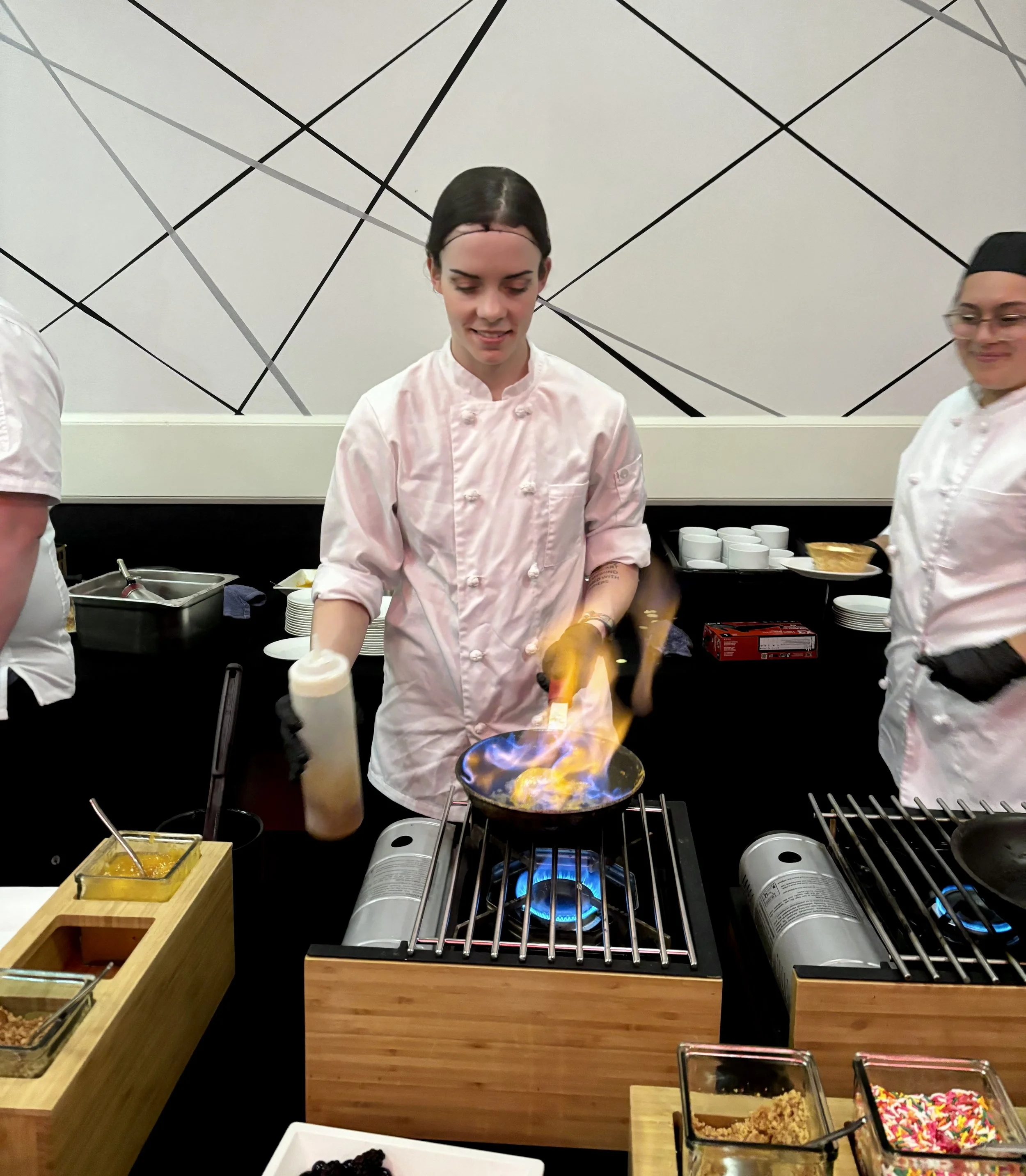 Interactive chef experience with live cooking and a dramatic flame presentation designed to enhance the guest experience at a special event