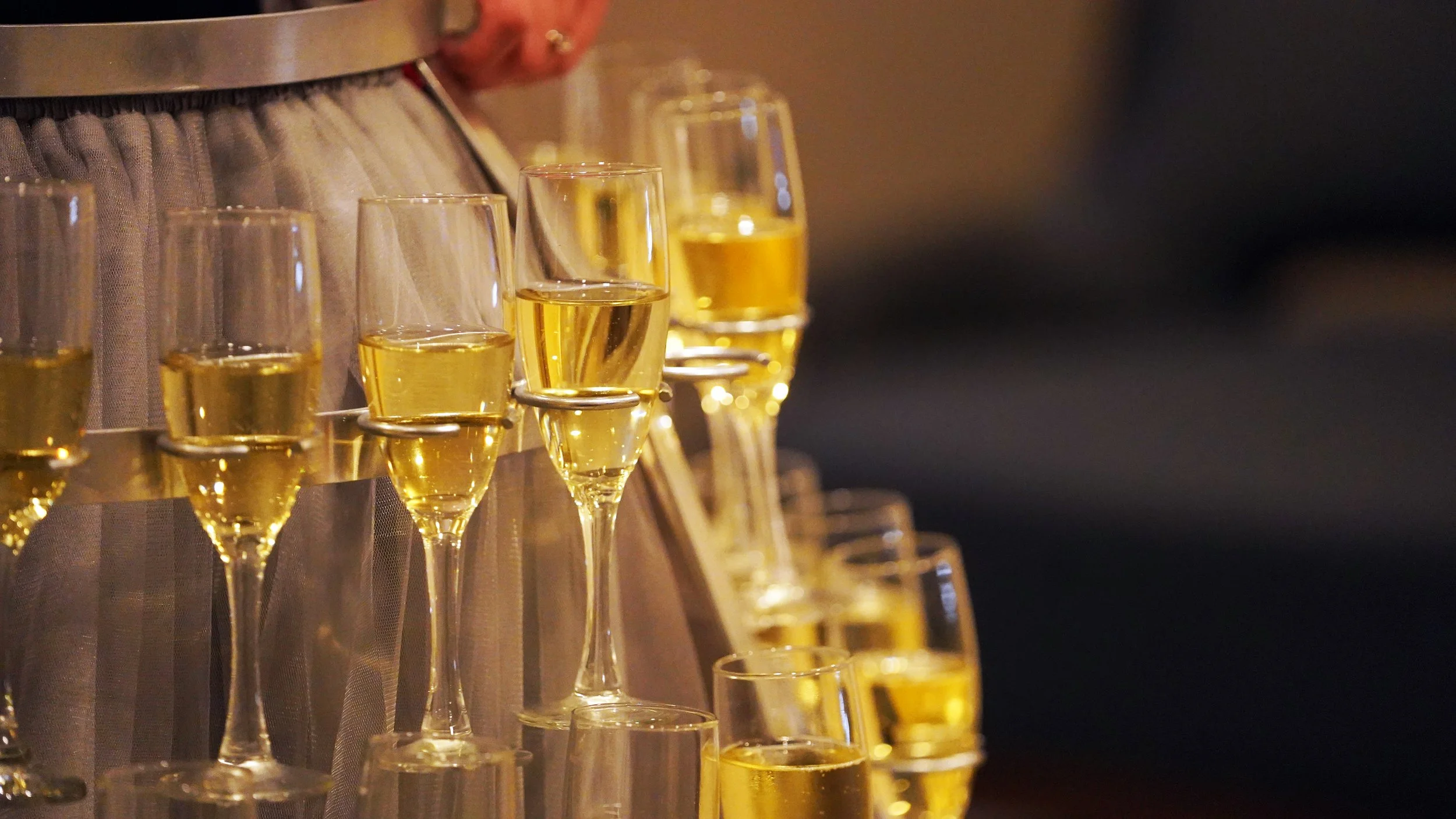 Champagne flutes arranged as part of a custom event feature, highlighting thoughtful details designed to elevate the guest experience.