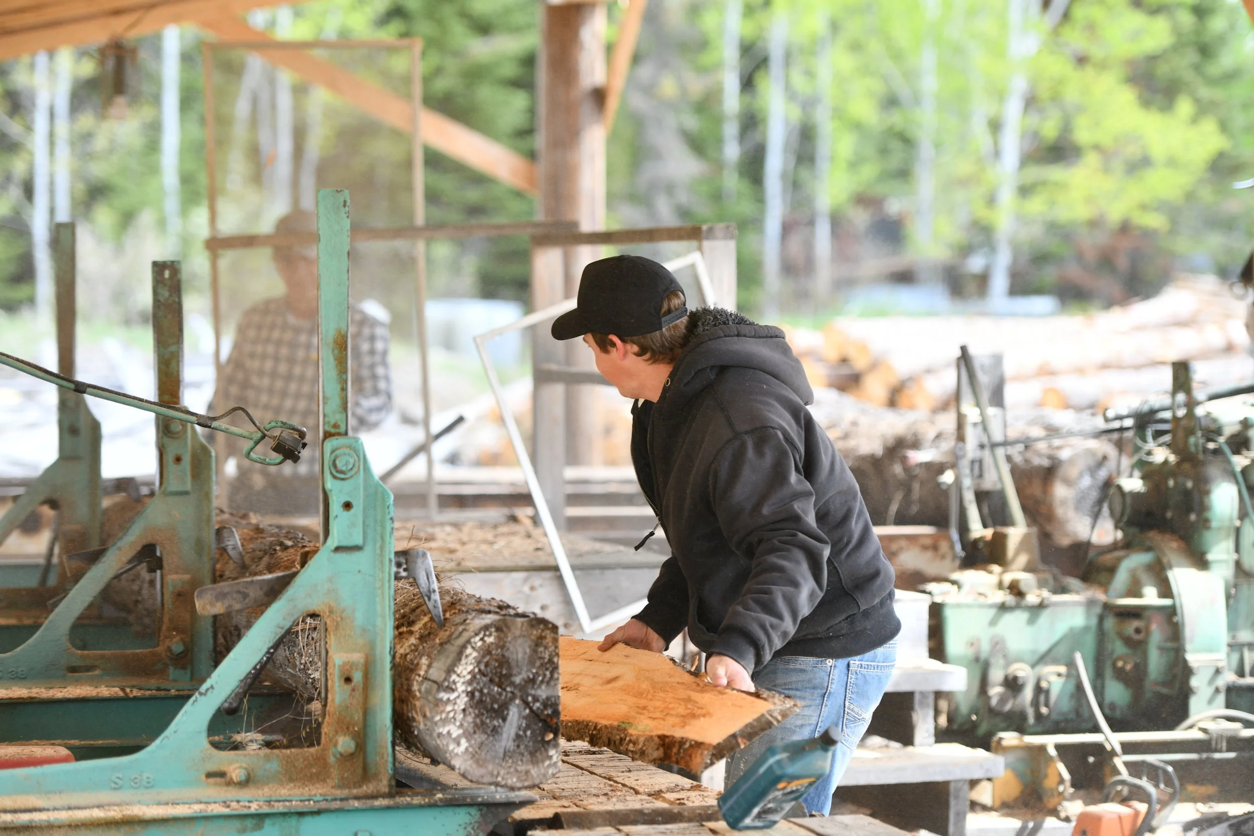 Sawers send a log through the sawmill to make 2x6 lumber