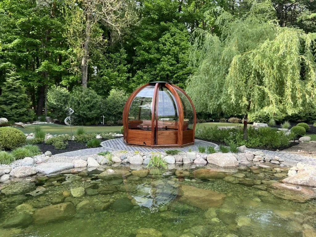 An Alpenglobe in a verdant forested garden