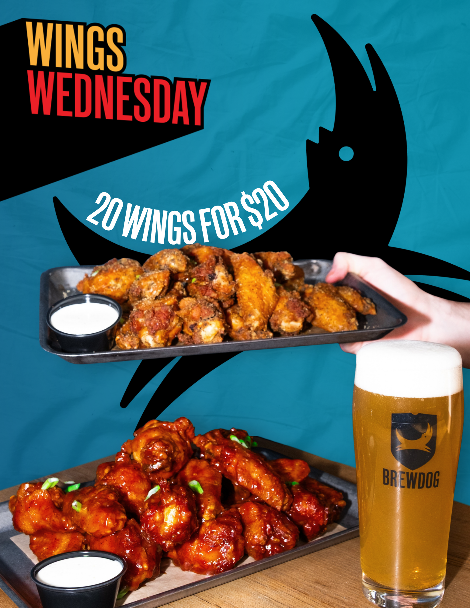 A tray of buffalo chicken wings covered in sauce, served with a side of ranch dip in a small cup, alongside a glass of beer labeled 'Brewdog'. The background features a promotional poster for Wings Wednesday offering 20 wings for $20.