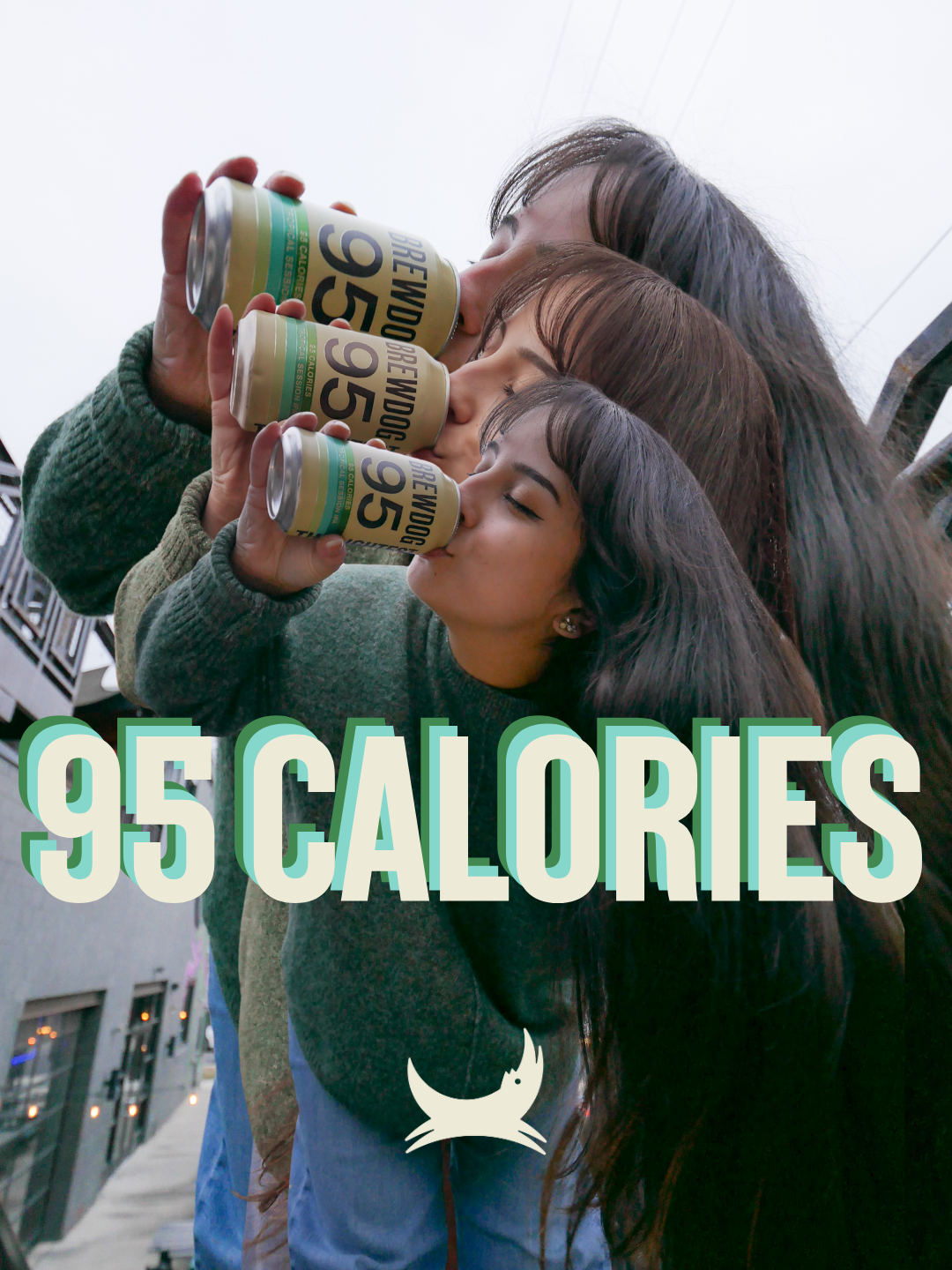 Three young women sharing a single beer bottle outdoors, with a text overlay indicating "95 Calories" and an icon of a devil.