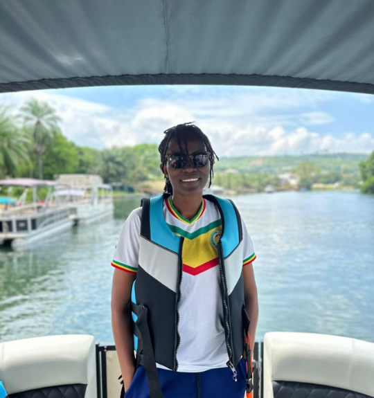 A young lady standing in a boat on  Lake Volta in Ghana
