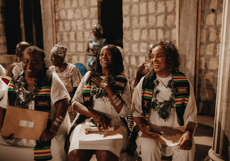 Travellers sharing a happy moment at a Ghana naming ceremony