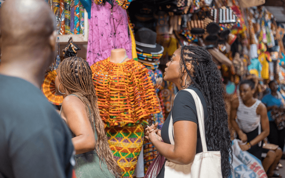 A group of diasporans shopping at the Accra Arts Centre for local crafts