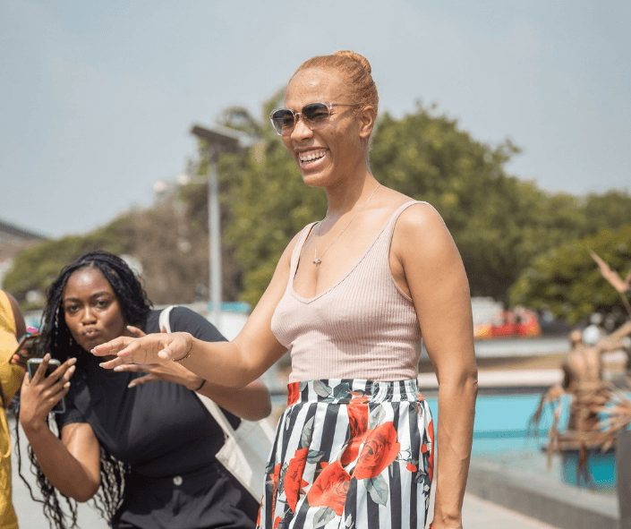 Two women in an exciting mood posing for a photo at the Kwame Nkrumah Memorial Park In Ghana