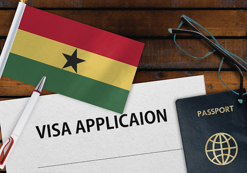 A photo of a traveler's Passport, visa application form and a Ghana flag