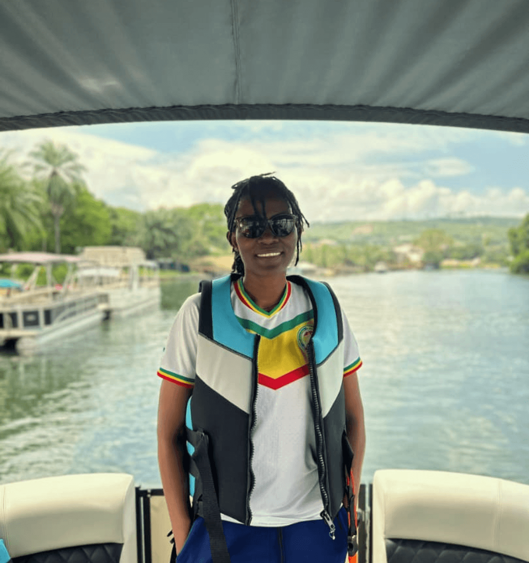 A lady standing in a boat on Lake Volta in Ghana