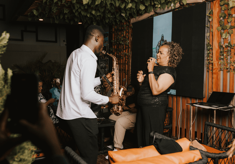 Traveller dancing to music with  a saxophone player