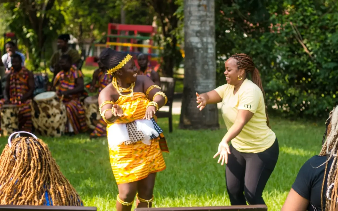 Two women dancing together in a drumming and dance tour experience