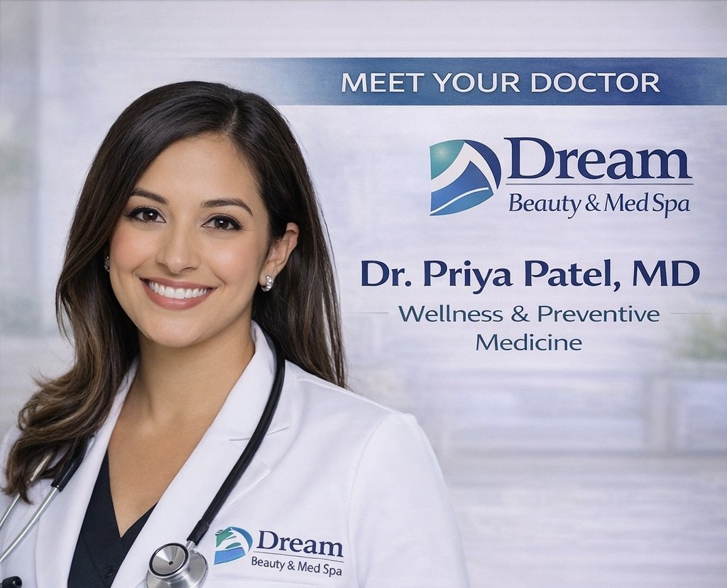 A smiling female doctor in a white coat with a stethoscope around her neck standing in front of a sign that reads "Meet Your Doctor, Dream Beauty & Med Spa, Dr. Priya Patel, MD, Wellness & Preventive Medicine"