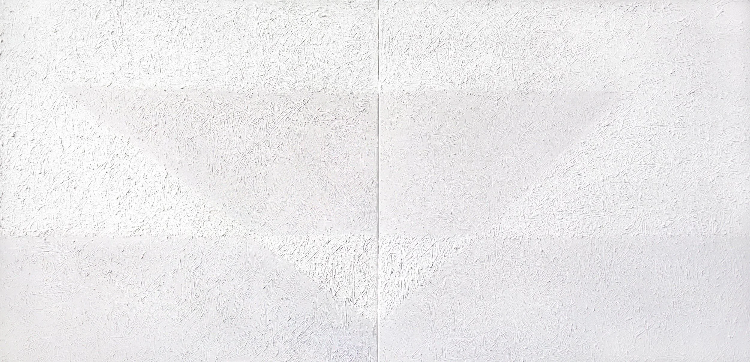 Close-up view of a white textured wall with a vertical seam in the middle.
