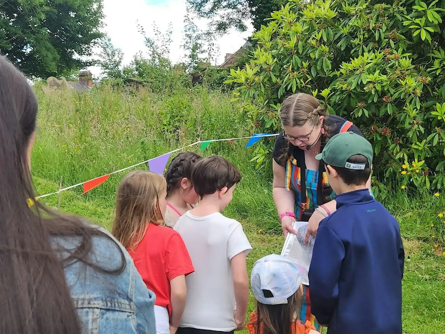 A colour photograph of Dr. Robyn Atcheson leading a Junior Historians Club session for a group of children.