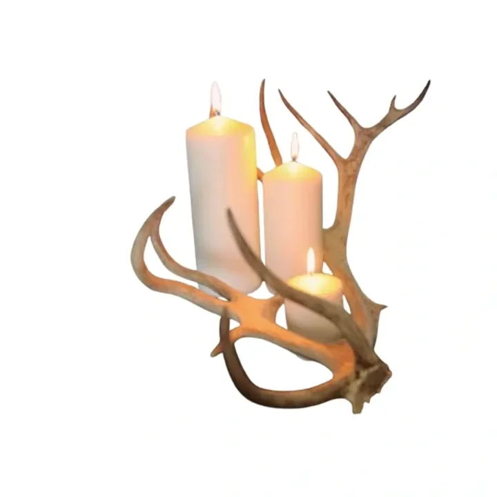 Decorative wall piece featuring candles and antlers.