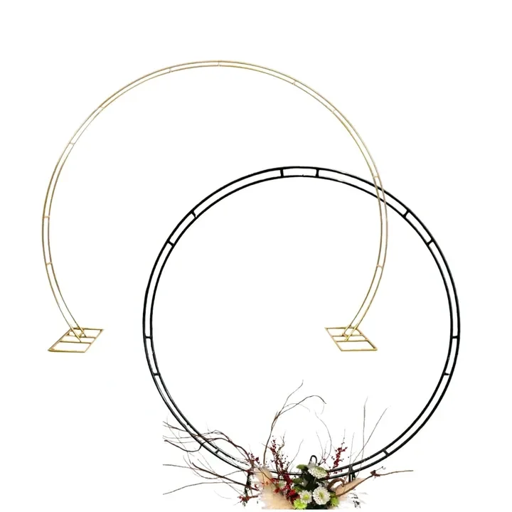 Decorative metal circular wedding arch with twigs and flowers at the base.