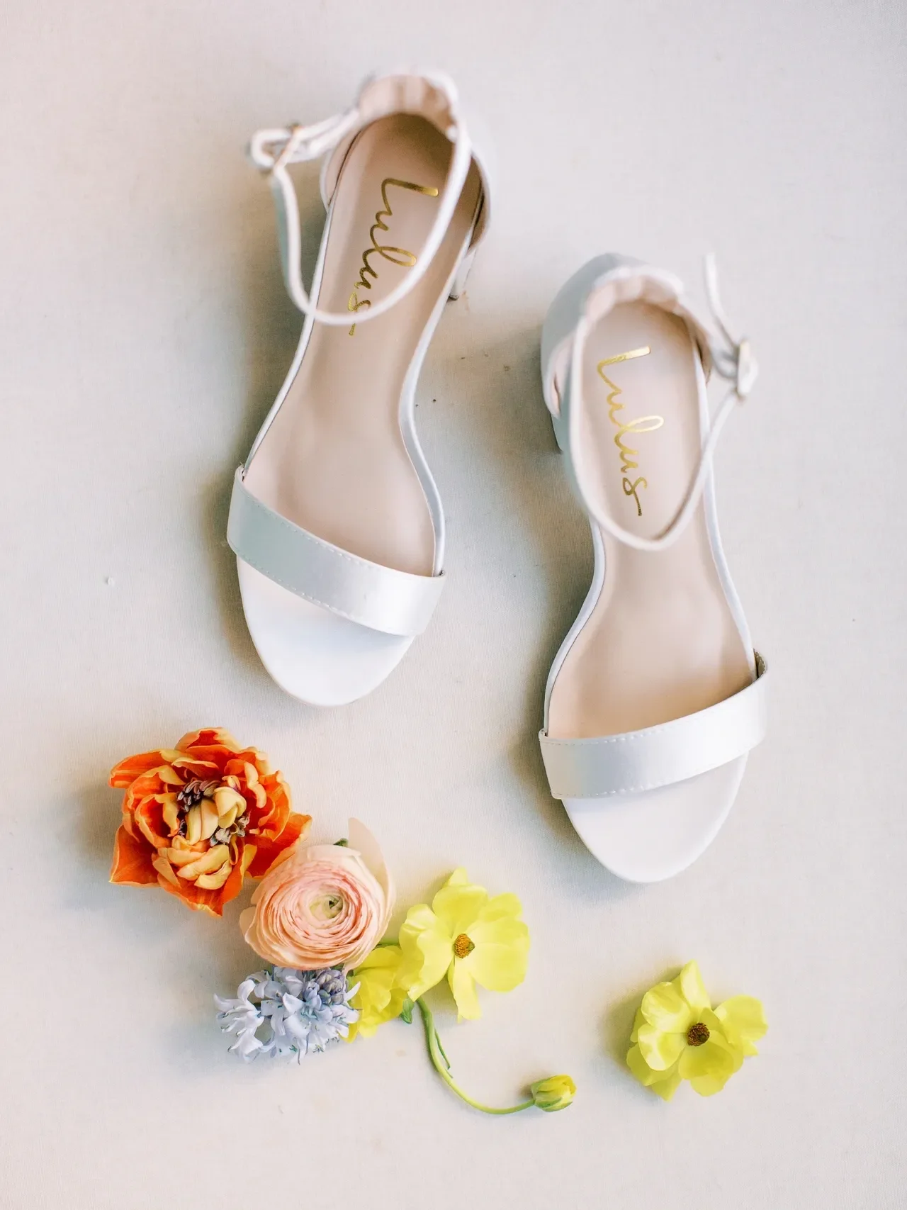 Spring wedding florals with white wedding shoes from Lulus.