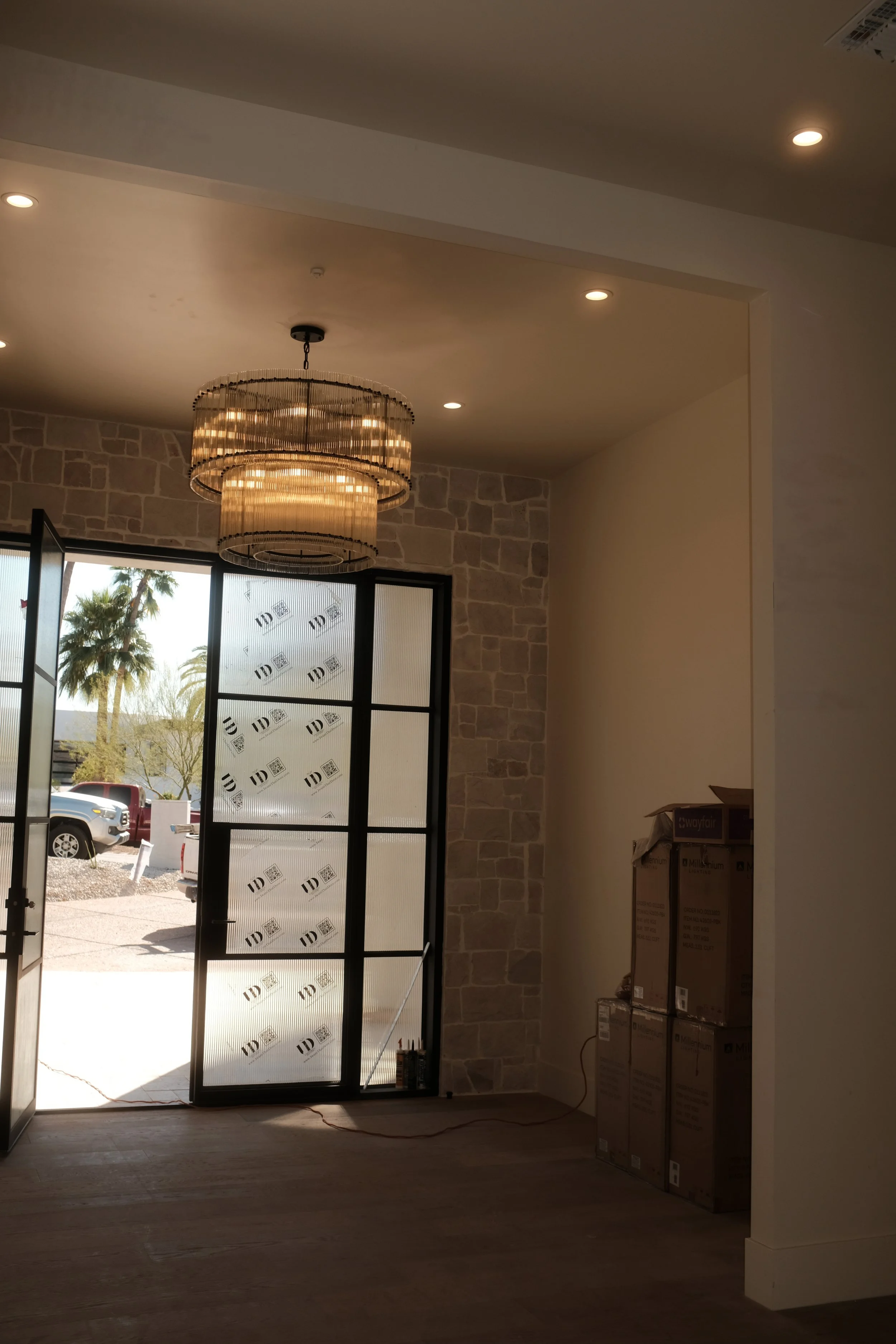 Custom home rebuild in Paradise Valley featuring stone walls, open doorway, and staged interior construction details