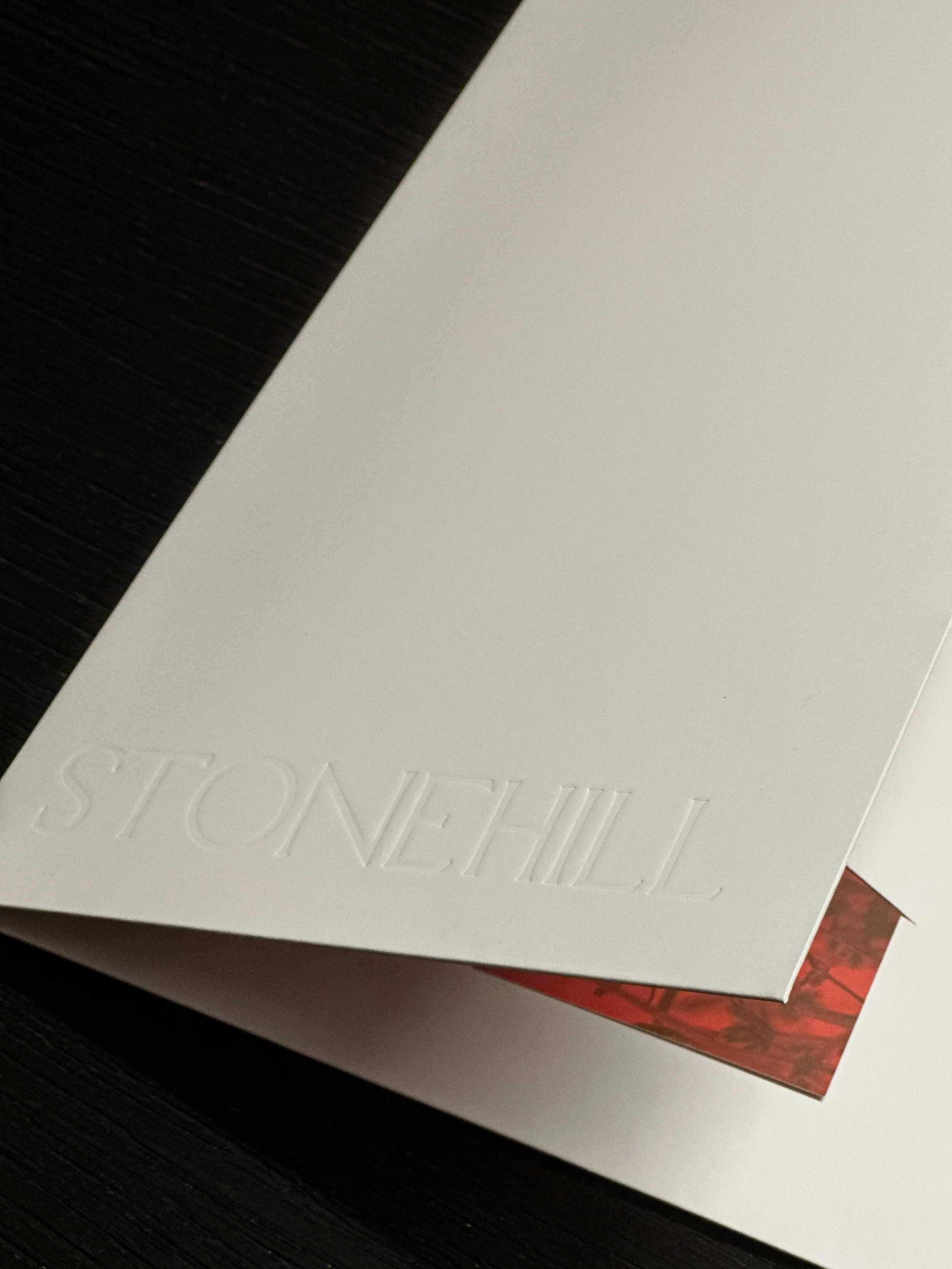 Image of the folder closed with the "Stonehill" logo blind debossed into the cover.