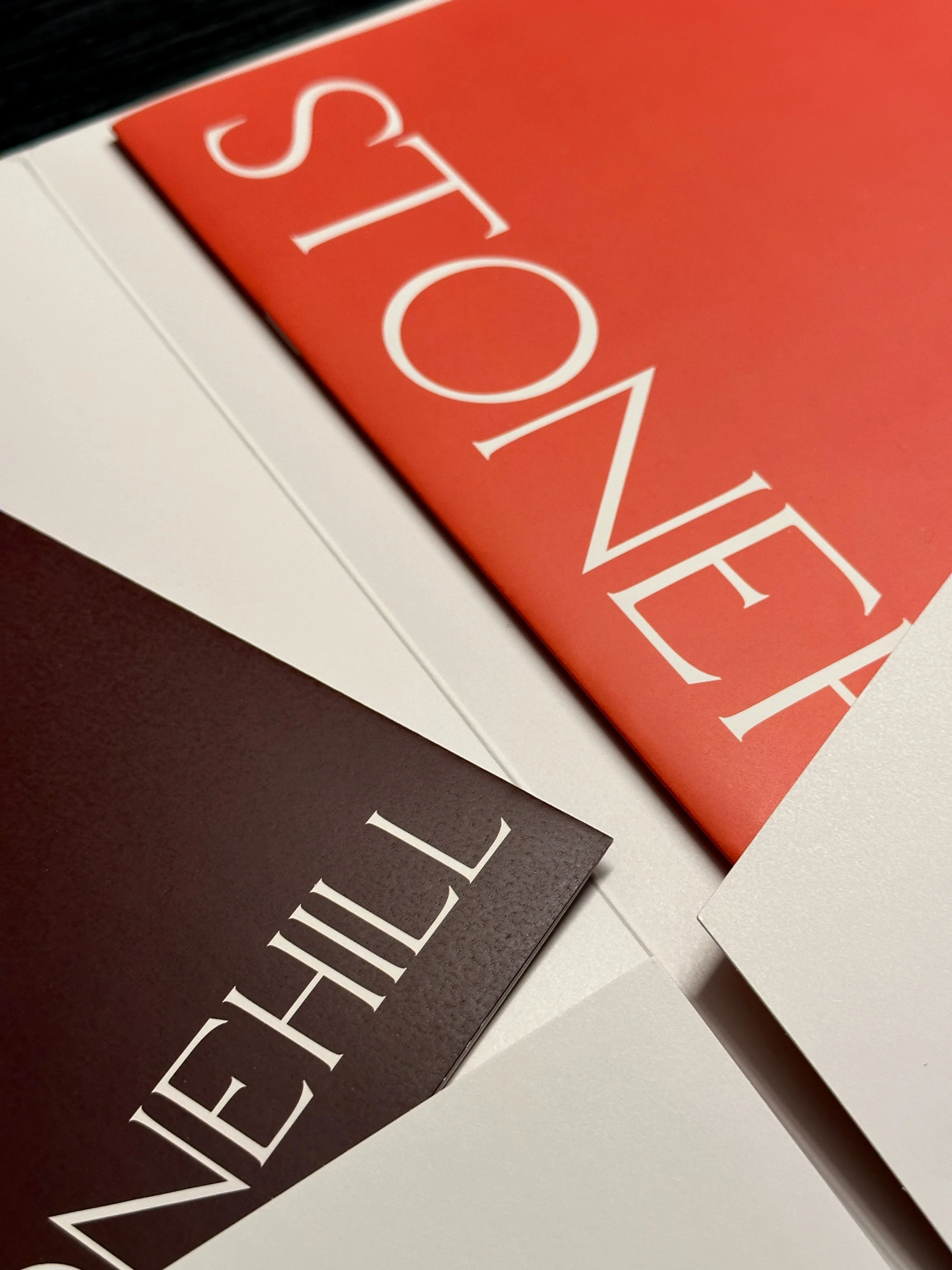 Image of the folder open with an abstract zoom showing the logos on the brochure and floorplan sheet.