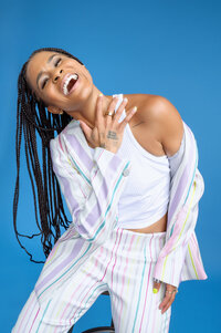 wellness influencer smiling on a vibrant blue background