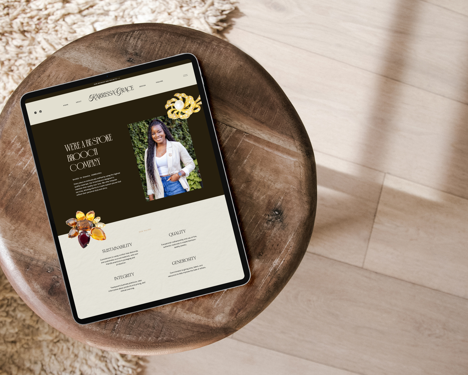 website mockup for a jewelry business featuring a deep burgundy and cream color palette, a minimal logo mark, product packaging and a brand pattern on mockup boxes