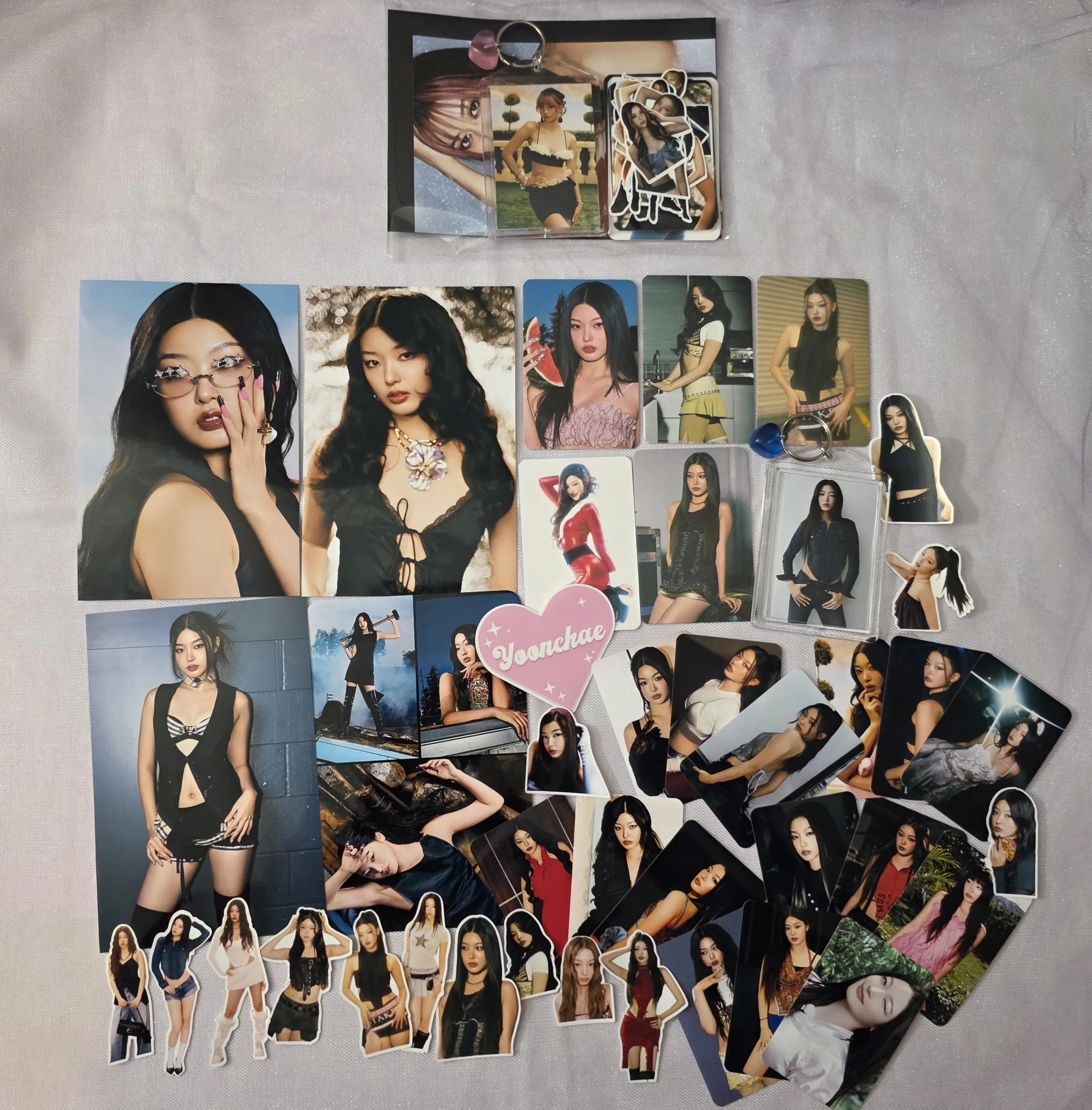 A Collection of K-pop photocards, stickers, and keychains.