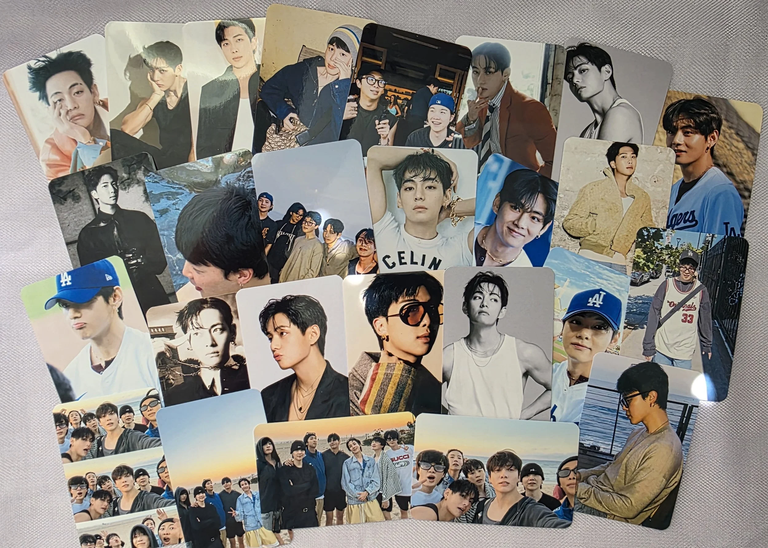 A collection of photo cards featuring a group of young men, some in casual and some in fashionable outfits, posing individually and in groups in various settings.
