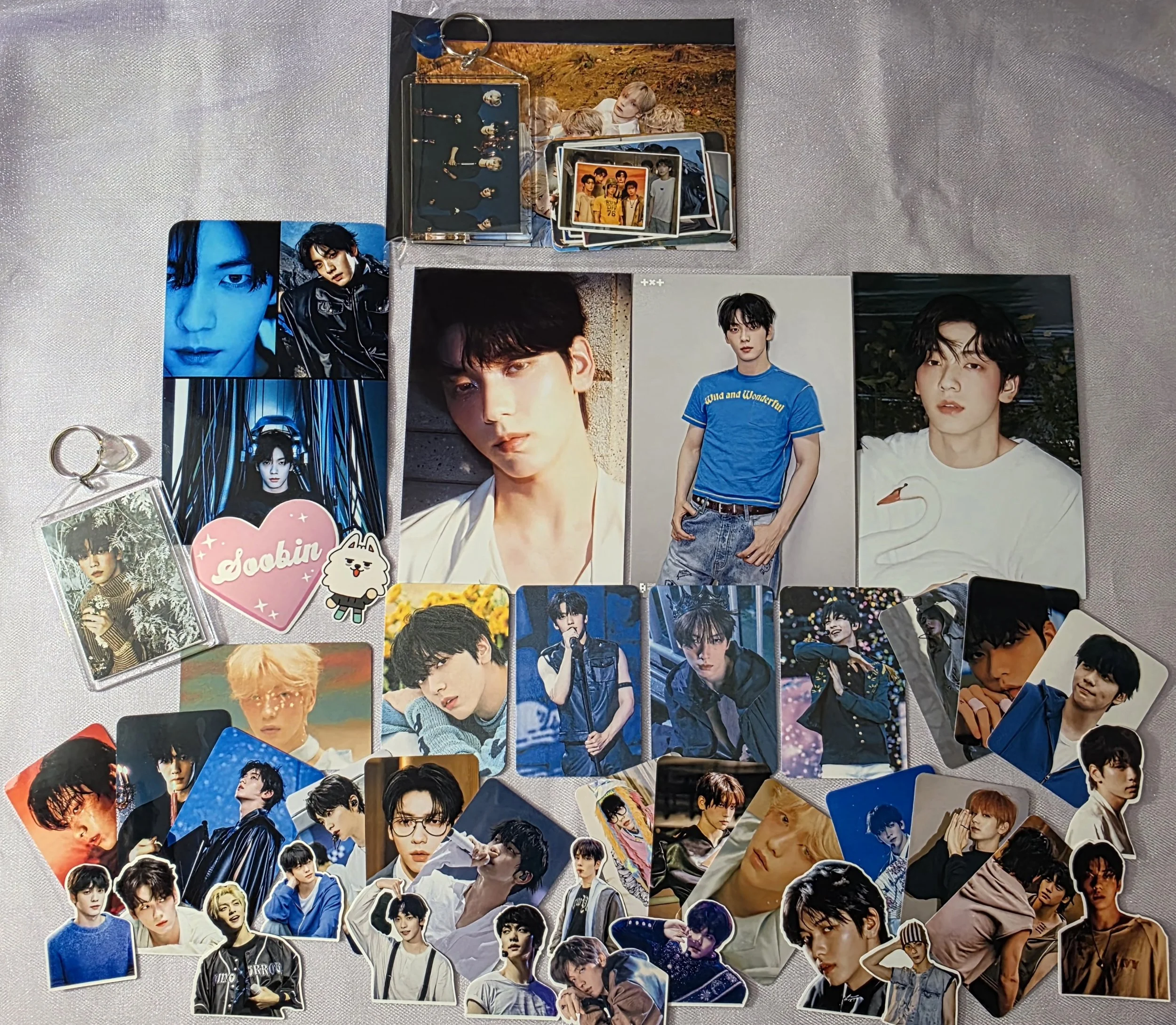 A Collection of K-pop photocards, stickers, and keychains.