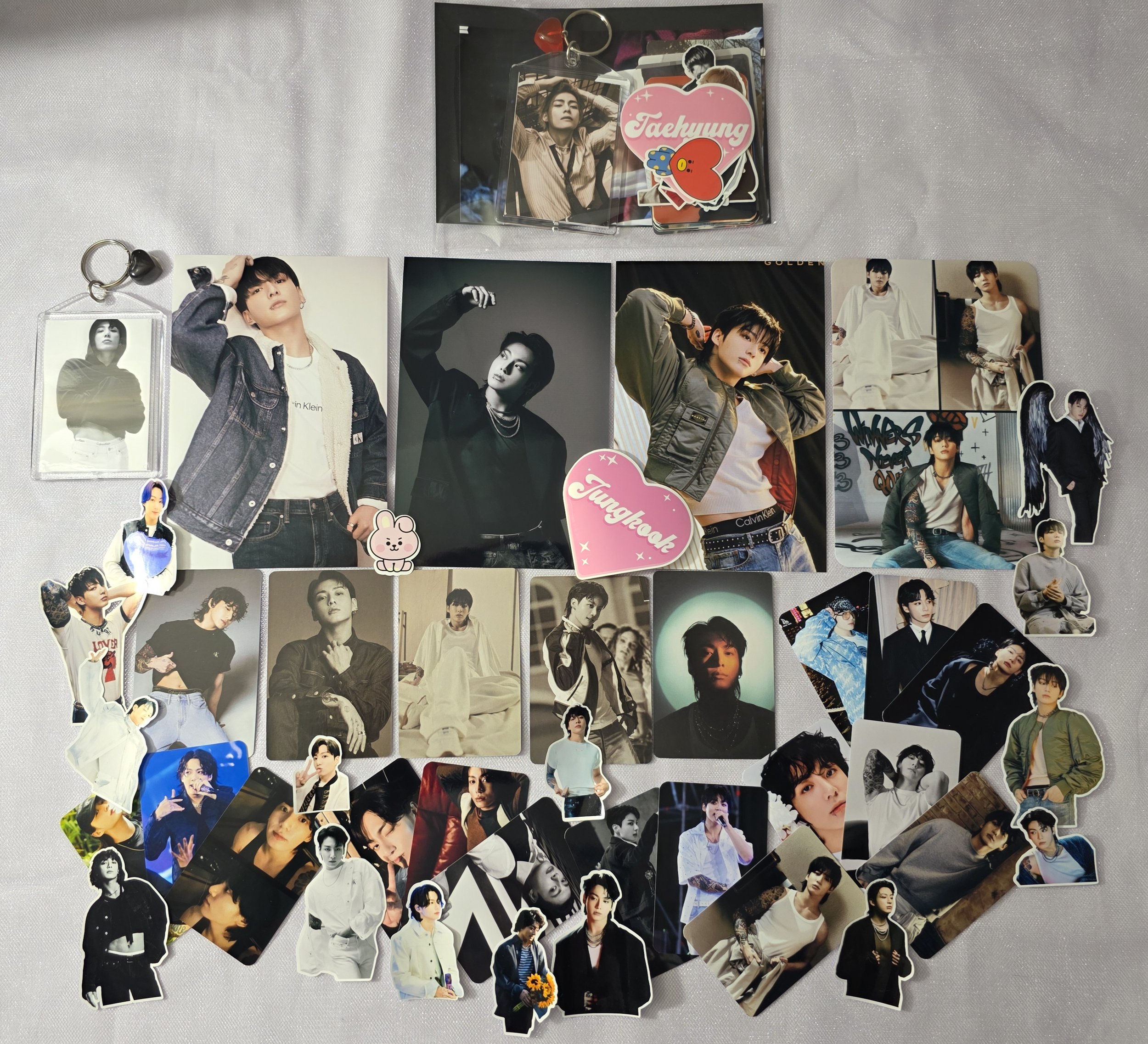 A Collection of K-pop photocards, stickers, and keychains.