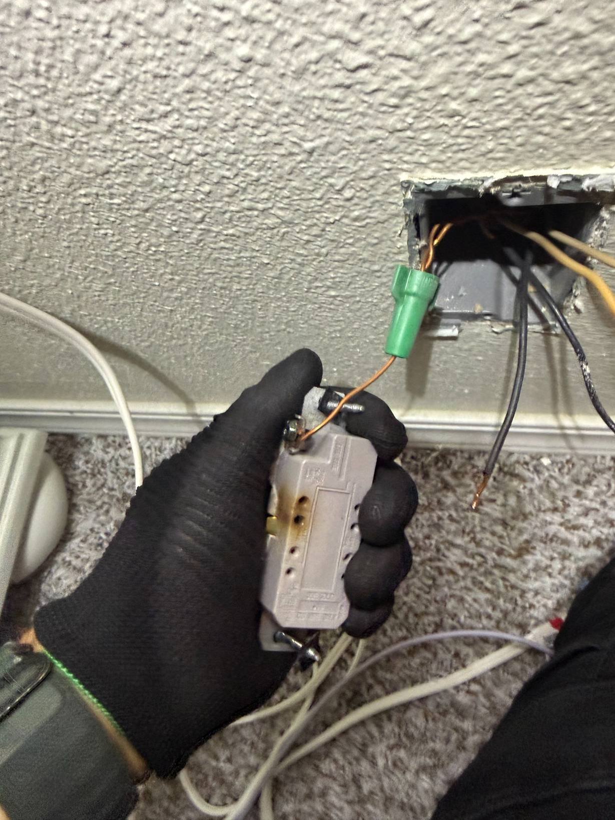 Residential wiring connection inspected and tested by an electrician during electrical troubleshooting and repair service.