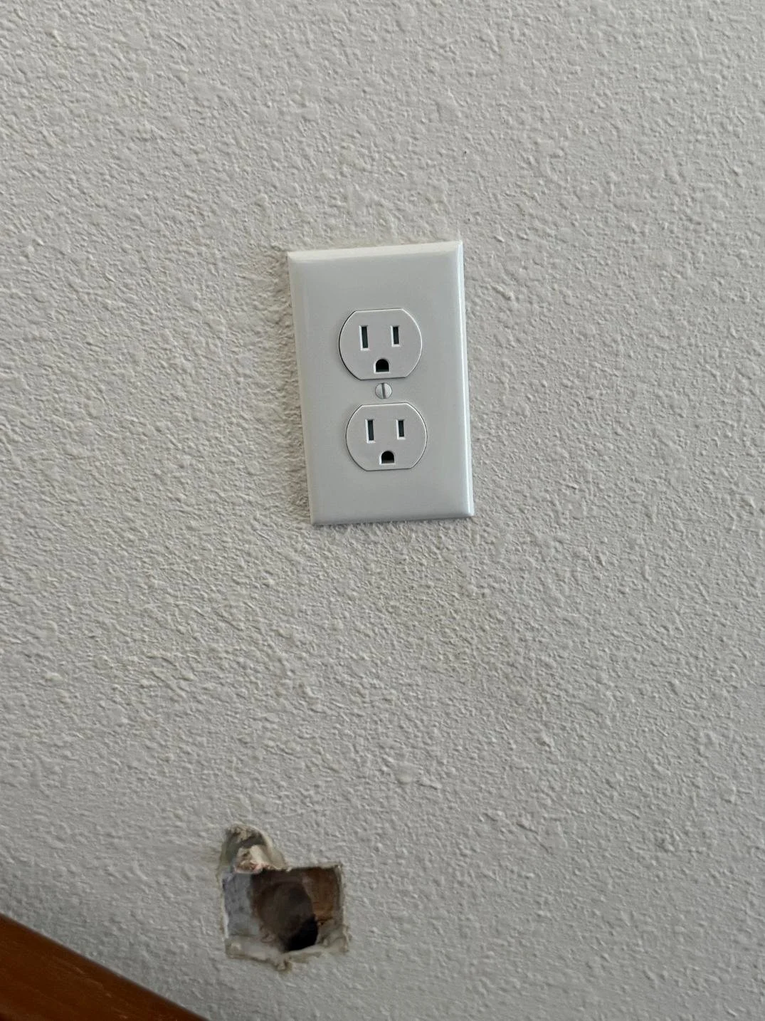 Finished residential electrical receptacle installed securely with a clean wall plate for safe and reliable household power.