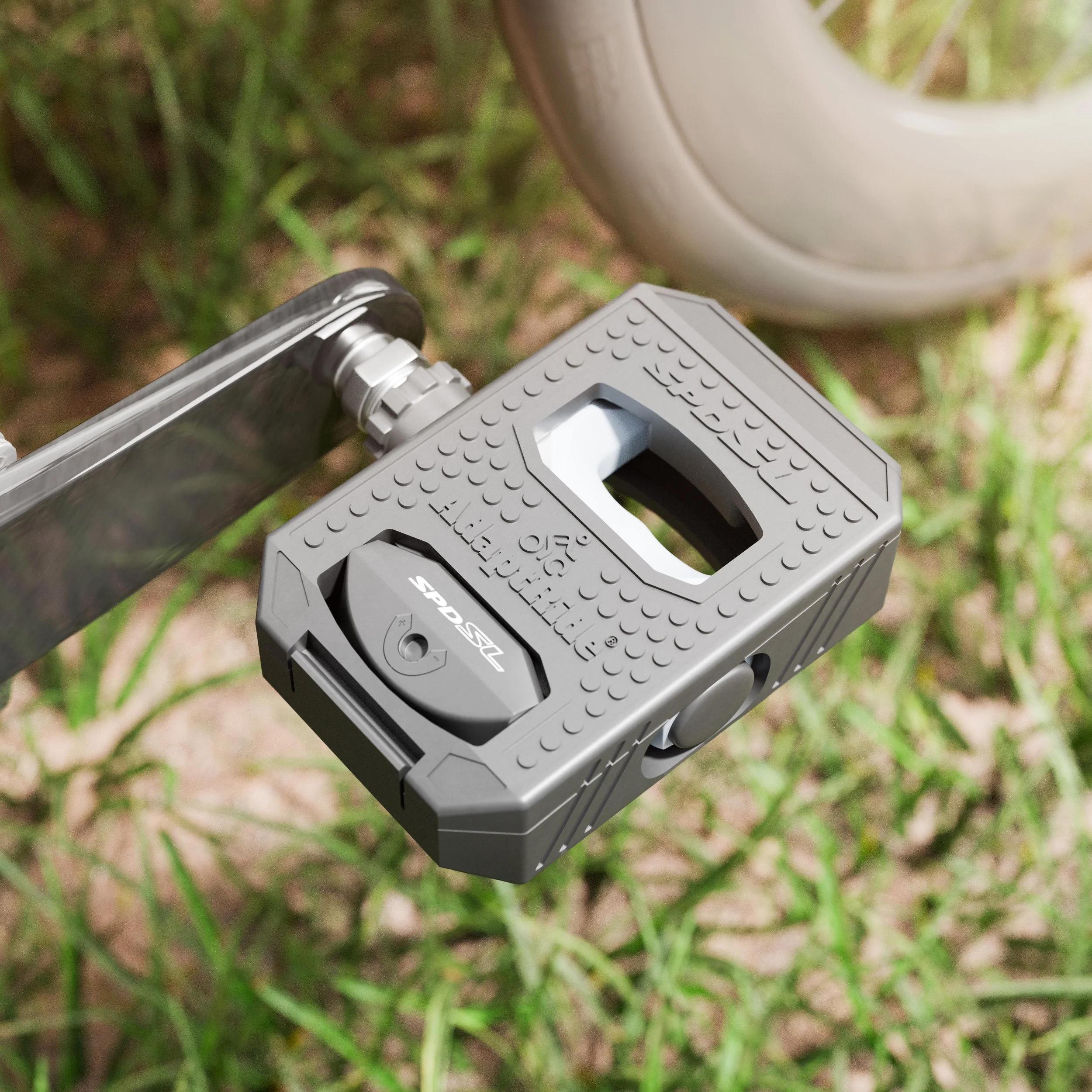 AdaptRide double-sided pedal adapter securely clipped onto a high-performance SPD-SL bicycle pedal.
