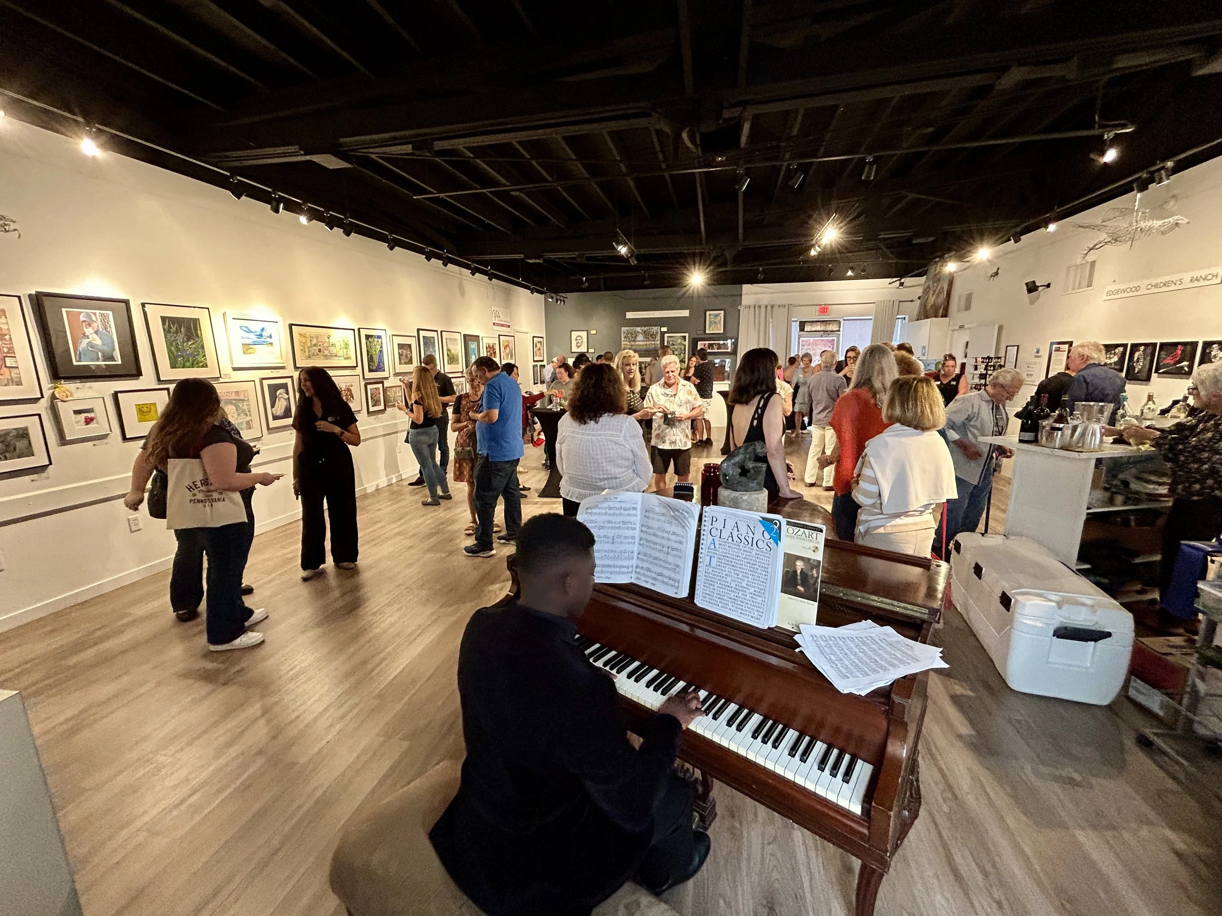 Roger playing piano at an art gallery.