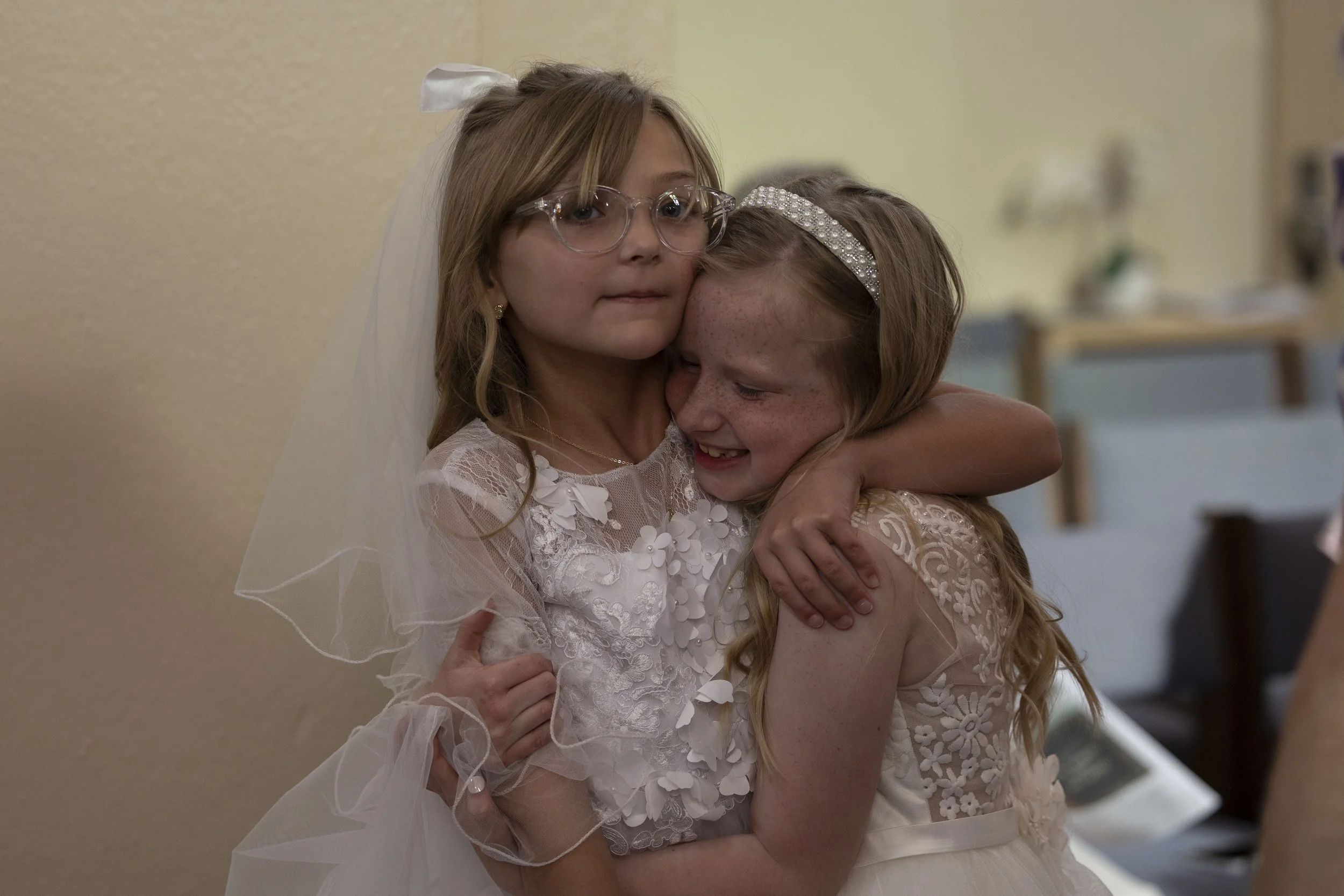 Marcella Haney hugs her friend Piper Jones after their first Communion April 11, 2026 at St. Andrew’s Catholic Church in Murphysboro, Illinois. 