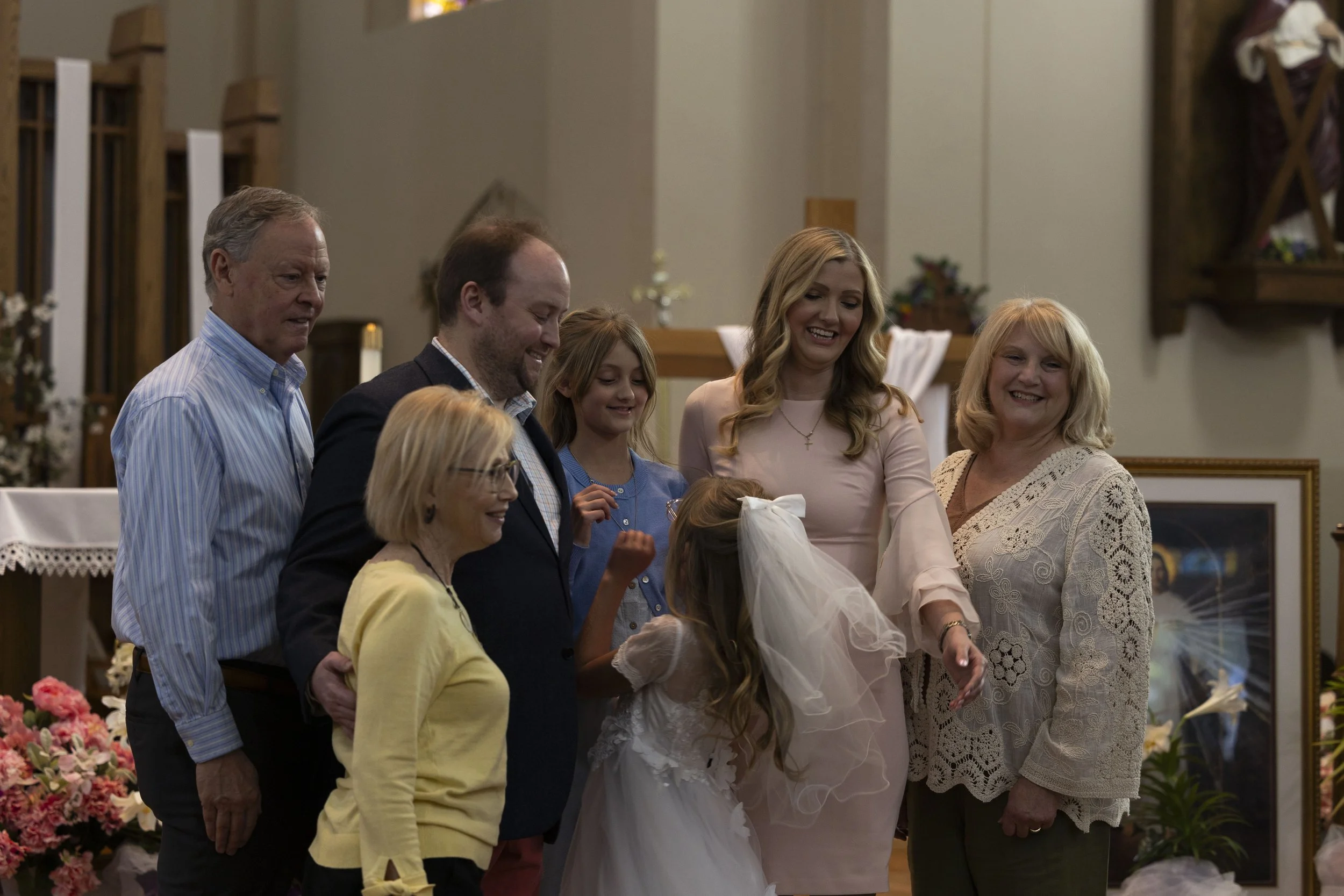 Marcella Haney turns toward her family right after they take a photos together after her first Communion April 11, 2026 at St. Andrew’s Catholic Church in Murphysboro, Illinois. 