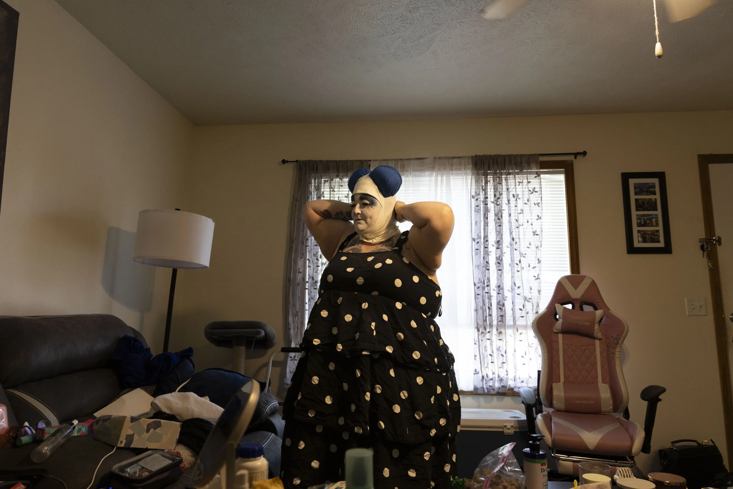 Christina Ivey buttons her scapular while getting ready for the Hunger Sale May 1, 2026 at her home in Carbondale, Illinois. 