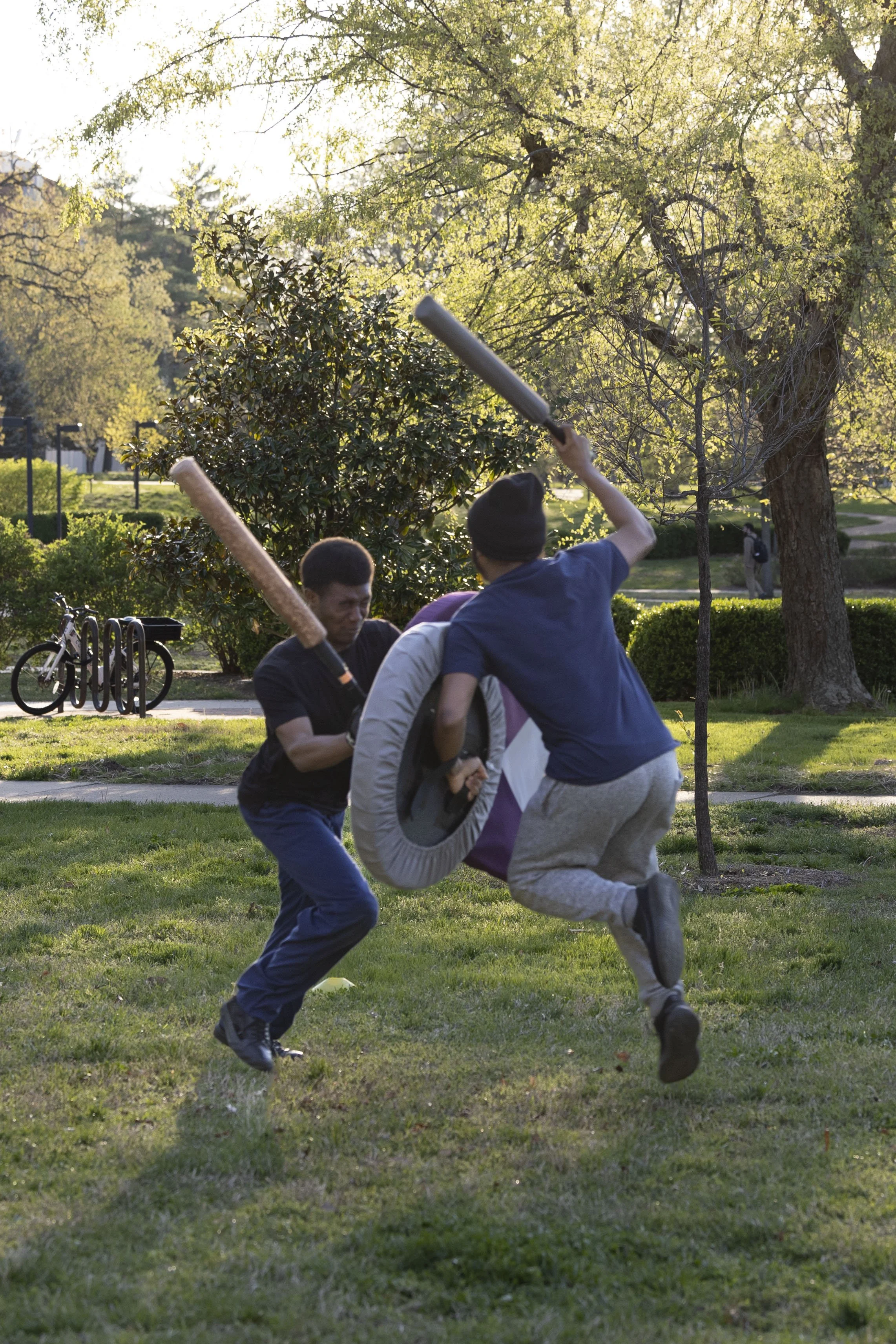 Quincy Washington (left) and Isaac Ramirez (Omen) jump towards each other to attack April 7, 2026 in front of Morris Library in Carbondale, Illinois. 