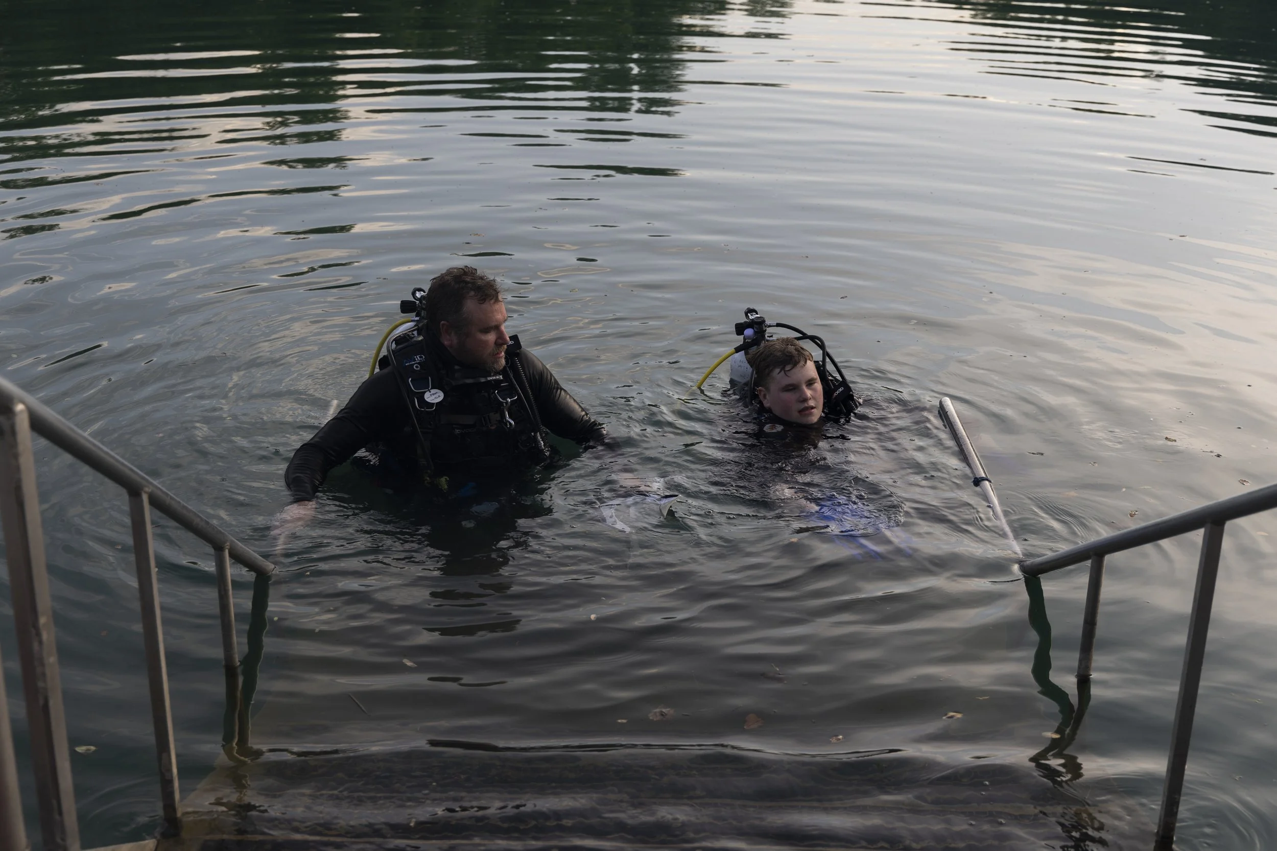 Allen Jones looks towards his son Adrian Jones, who is taking off his fins before stepping out of the Mermet Springs quarry. The father and son got certified together almost a year ago July 17, 2026 at Mermet Springs in Belknap, Illinois.