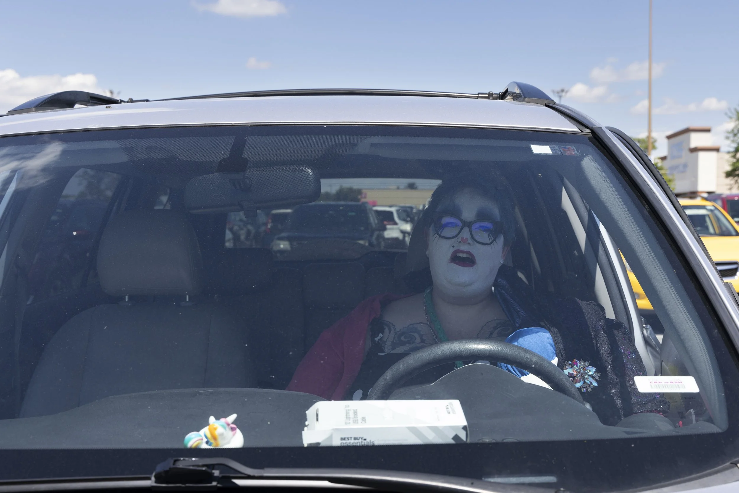 Christina Ivey (Sister Benadetta) sighs in relief after taking off her headpiece after volunteering at the Hunger Sale May 1, 2026 in her car in Carbondale, Illinois. 