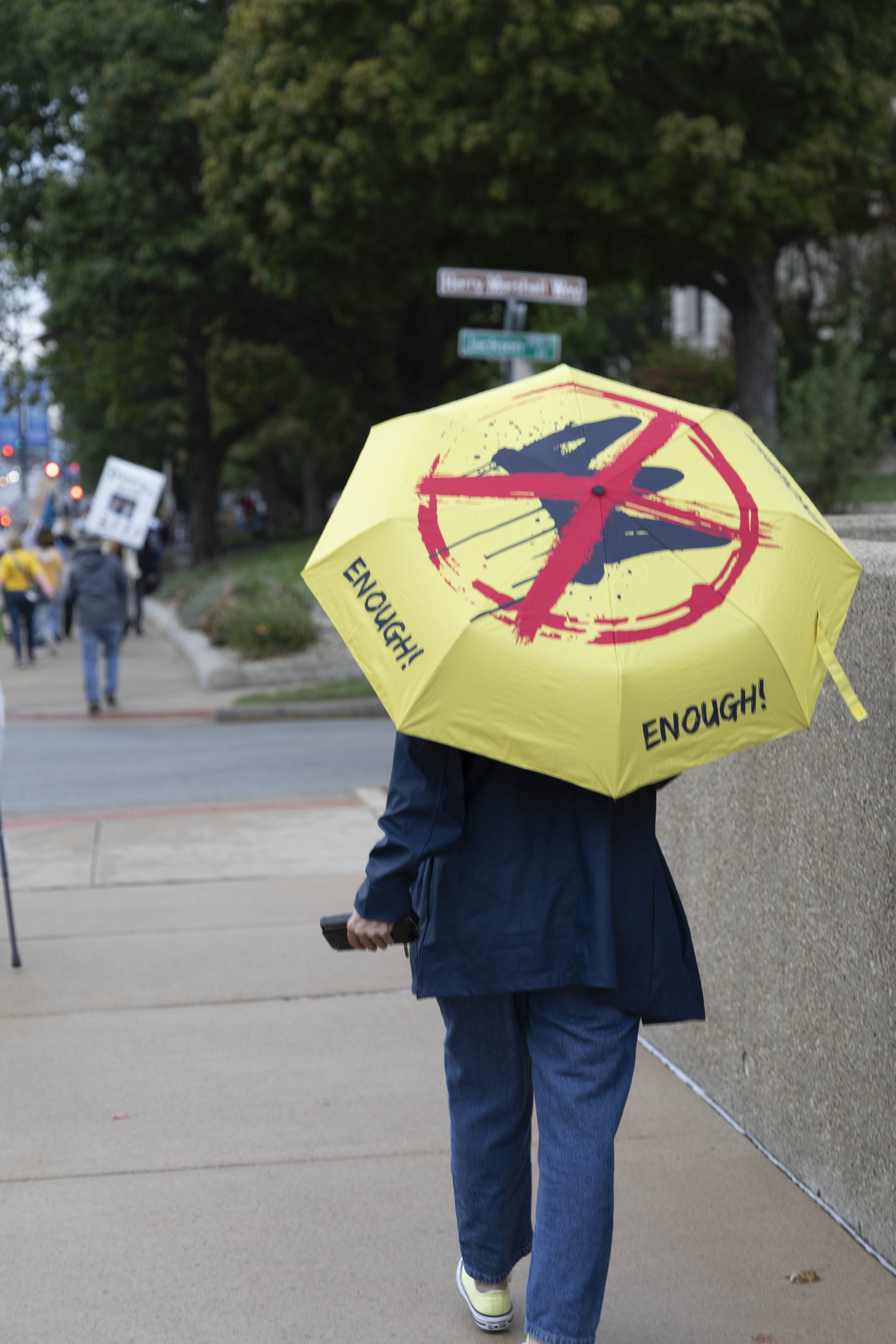 A protester walks down Second Street with a No Kings themed umbrella Oct. 18, 2025 in Springfield, Illinois.