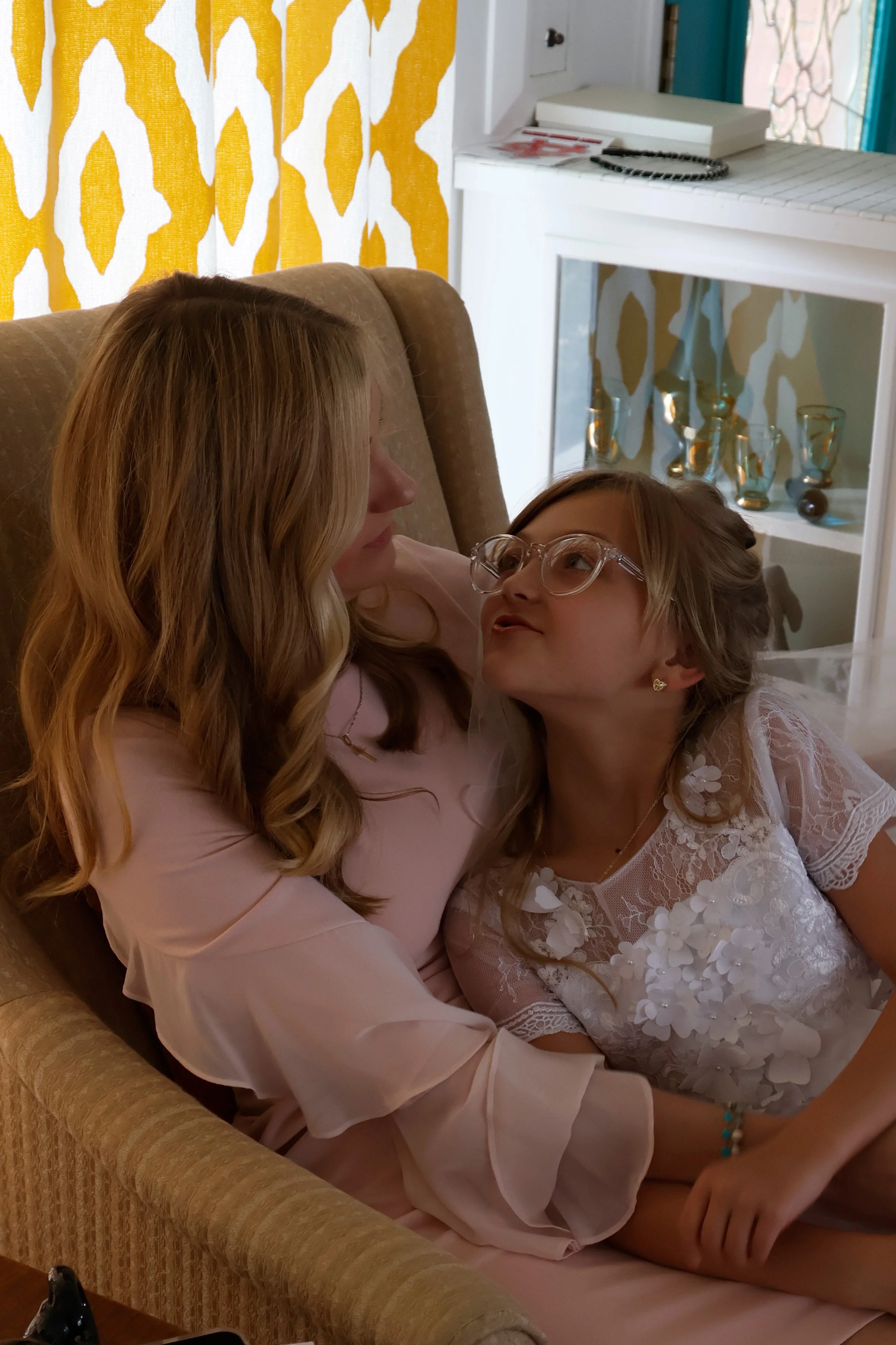 Marcella Haney hugs her mom before leaving to go to her first Communion April 11, 2026 at their home in Murphysboro, Illinois. 