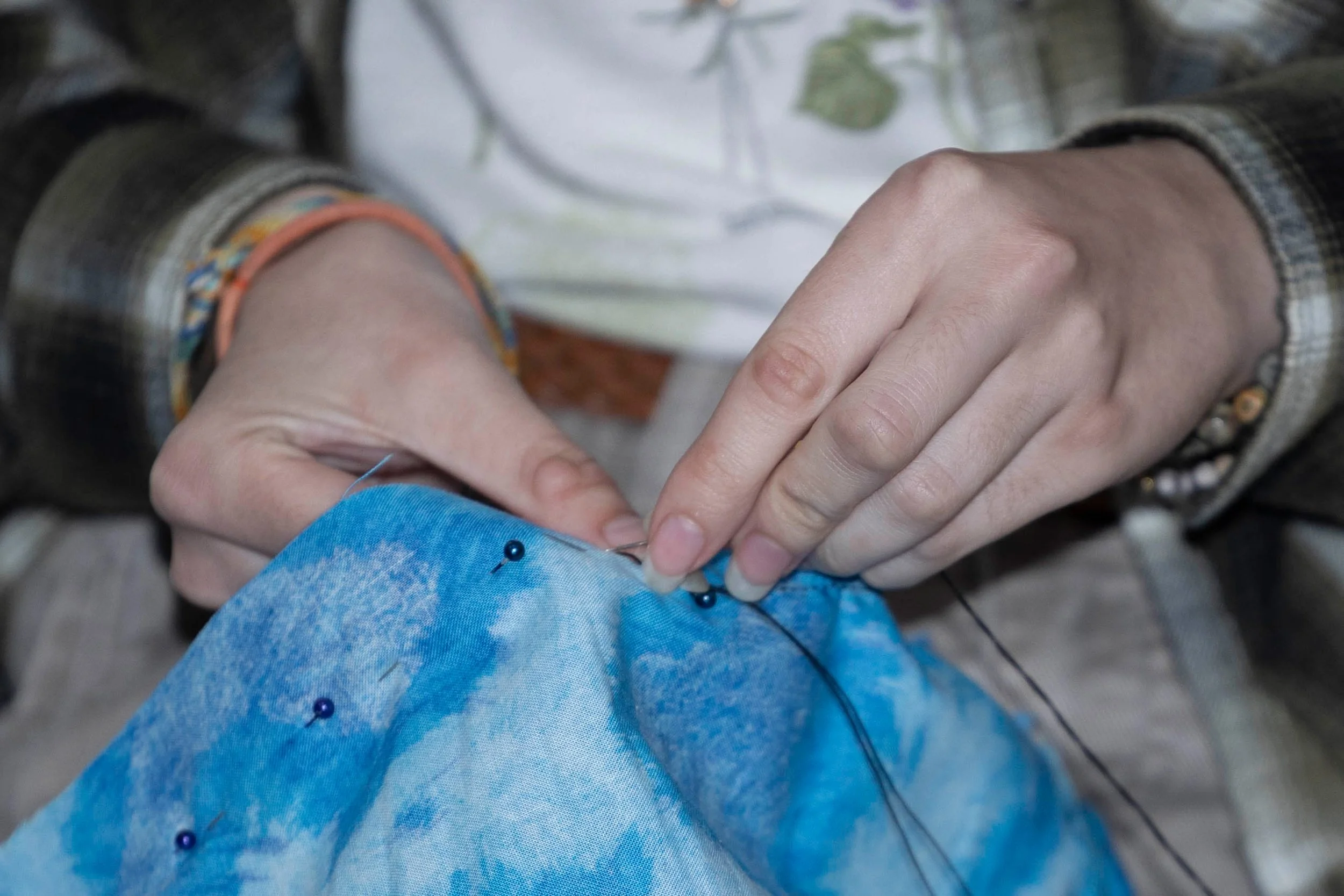 Wren Schelling sews together fabric to create a cover for a quarter staff at the Punic Wars March 28, 2026 at the SIU Rec Center in Carbondale, Illinois.