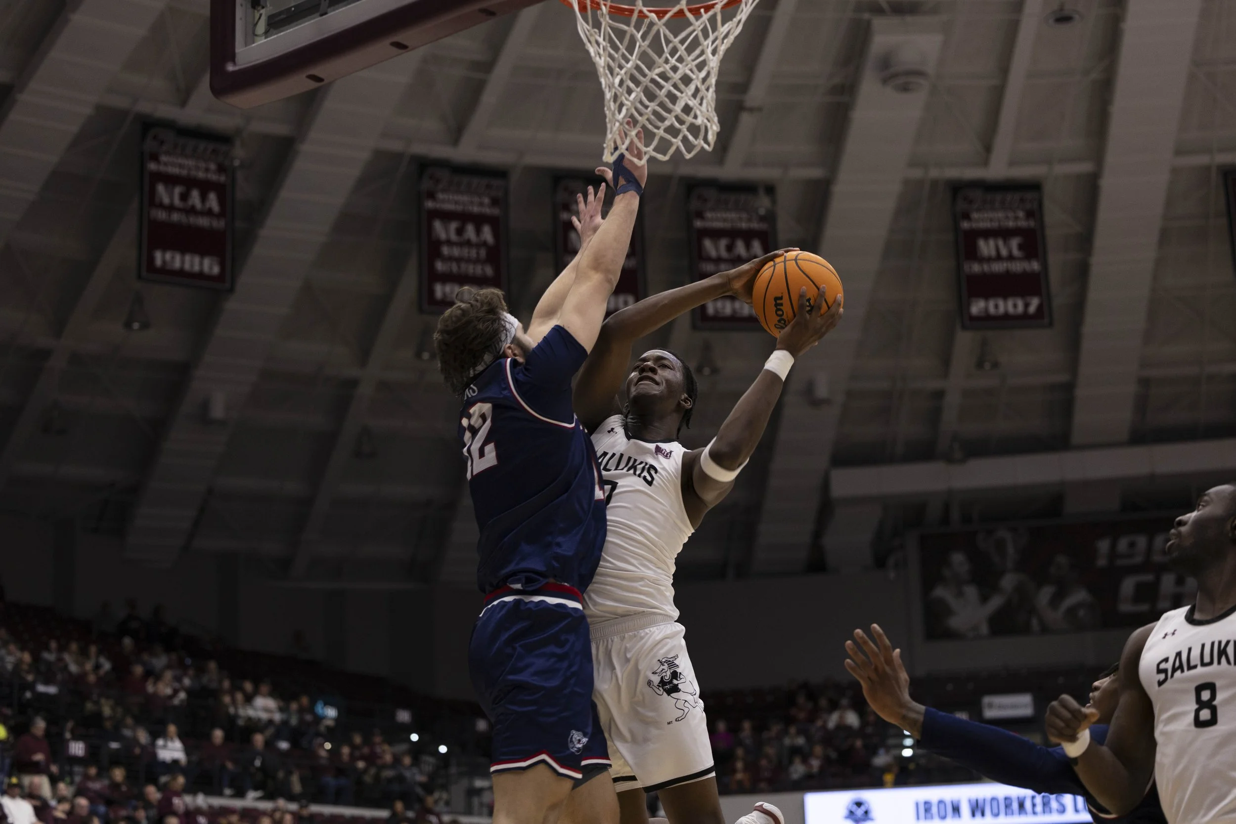 Rolyns Aligbe (0) jumps to score while Brigham Rogers (12) jumps to stop him Jan. 17, 2026 at the Banterra Center in Carbondale, Illinois.