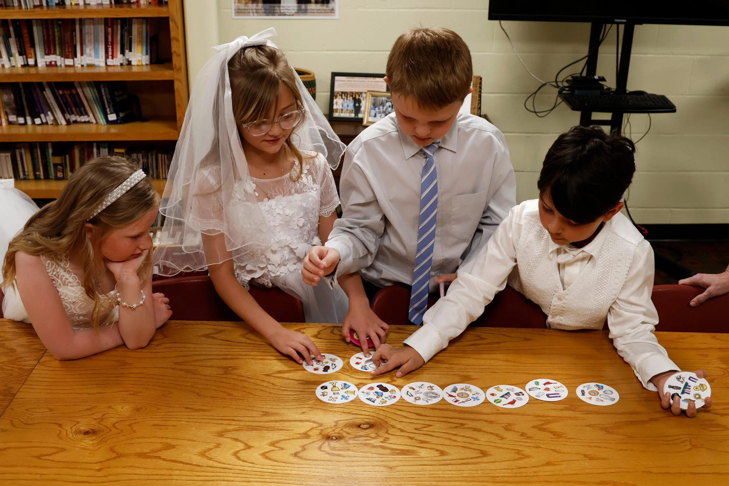 Kids in Mrs. Naas’ second grade class play games while waiting for their first Communion April 11, 2026 at St. Andrew’s Catholic Church in Murphysboro, Illinois. 
