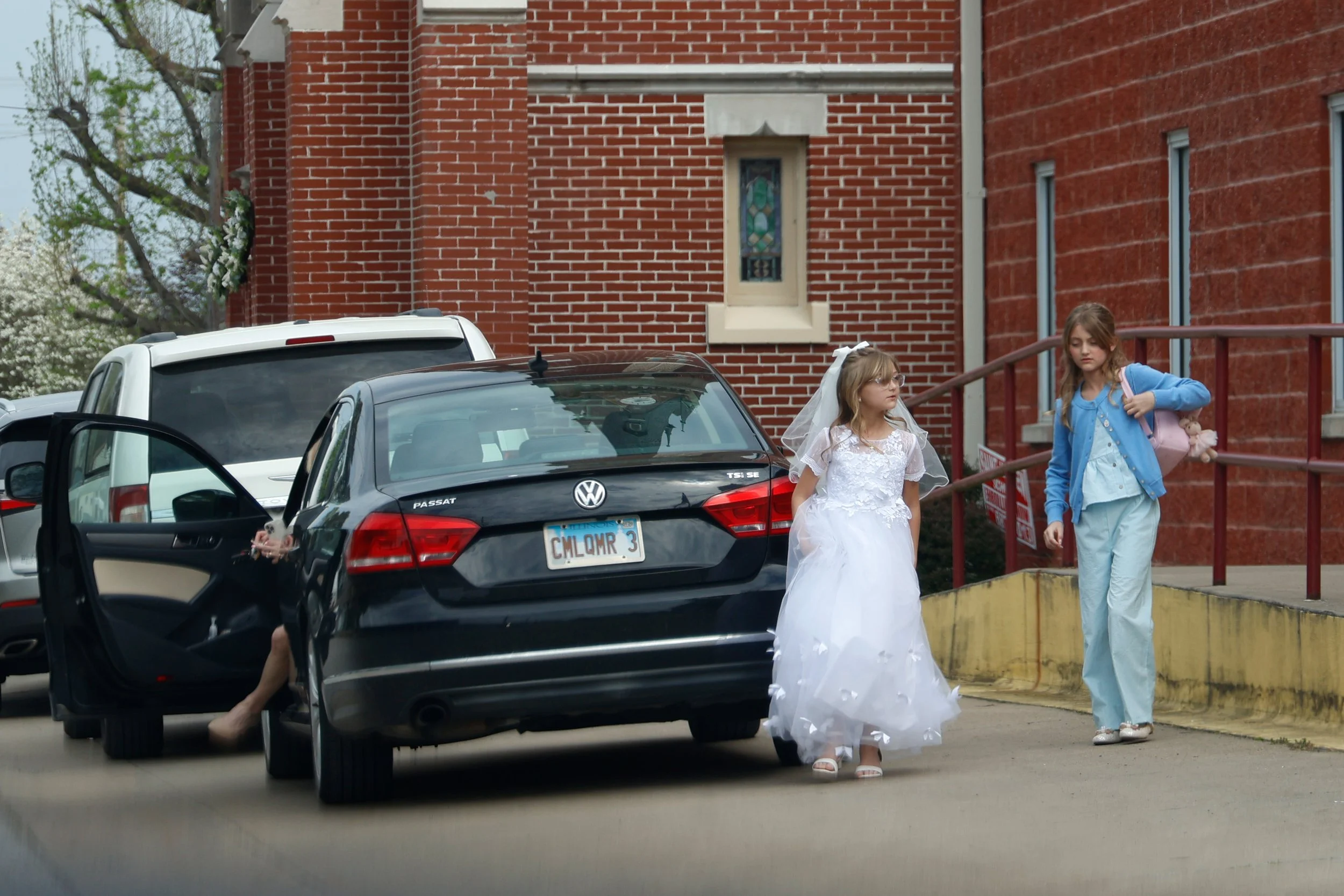 Marcella Haney and Lydia Haney exit the car in front of the church before Marcella’s first Communion April 11, 2026 in front of St. Andrew’s Church in Murphysboro, Illinois. 