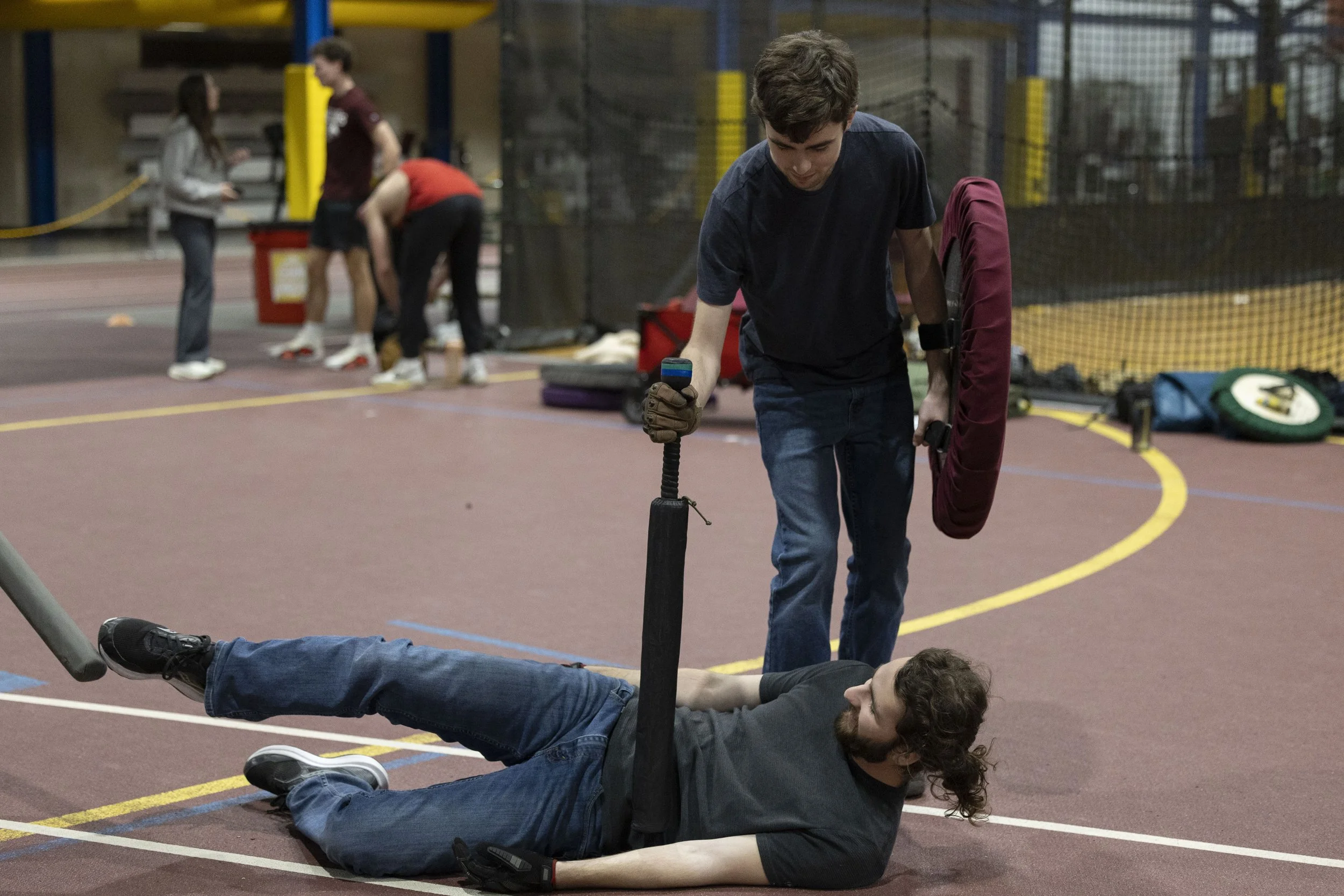 Ethan Loznicka stabs Ethan Whittaker in the stomach with a foam sword at practice Feb. 24, 2026 at the SIU Rec Center in Carbondale, Illinois. 