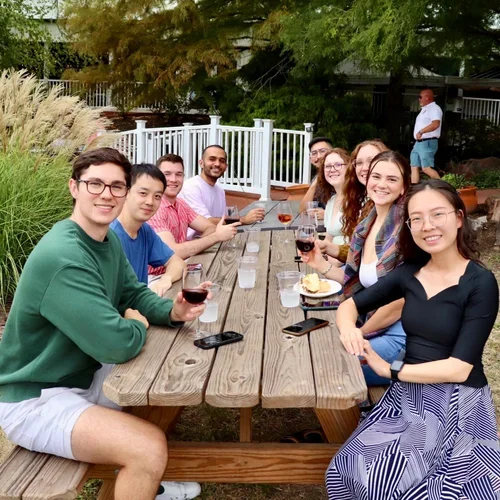 Friends gathering at Defiance Ridge Vineyards outdoor seating area enjoying snacks and wine.