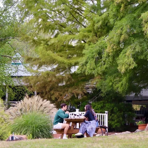 A couple enjoying wine on the outdoor patio at Defiance Ridge Vineyards