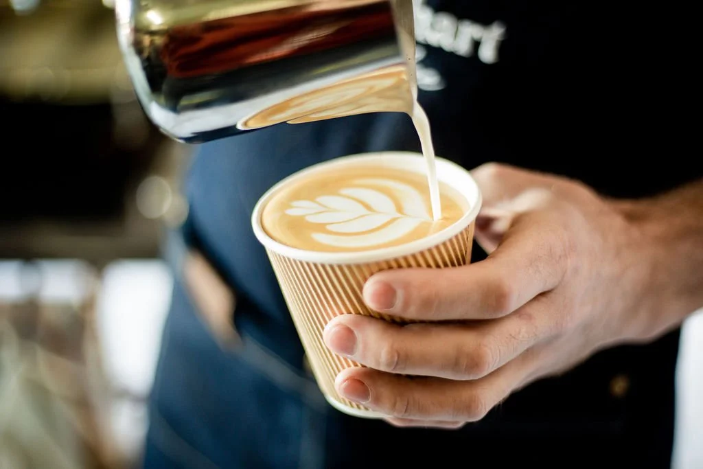 NYC Barista pouring a latte